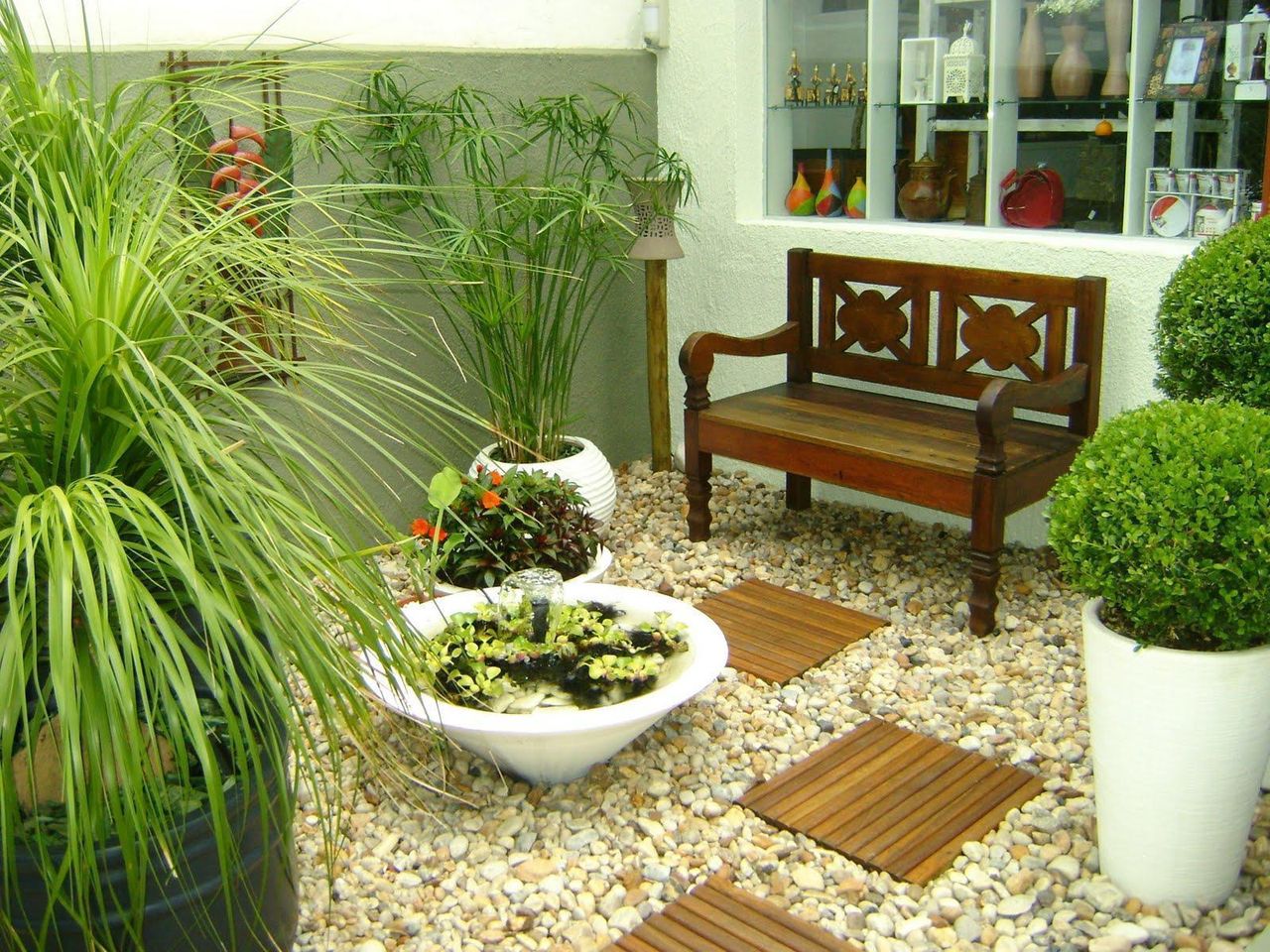 Jardim moderno interno com área para sentar.